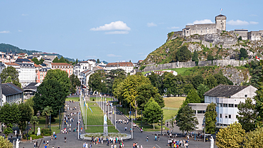 Urban landscape of Lourdes, a market town in the Pyrenees with Chateau Fort in backgroun,, Lourdes, Hautes-Pyrenees, Occitanie, France