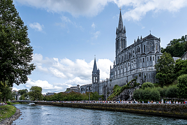 View from bank of Gave de Pau River, Sanctuary of Our Lady of Lourdes, Catholic Marian shrine and pilgrimage site, Lourdes, Hautes-Pyrenees, France