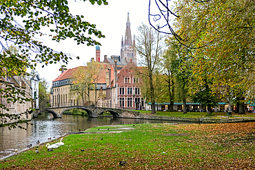 Bruges, Belgium – View from Wijngaardplein overlooking the exterior of the Princely Beguinage Ten Wijngaerde. A historic site with whitewashed façades, it reflects the city's medieval charm.