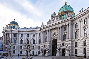 Vienna, Austria – View of St. Michael's Wing at Michaelerplatz, the grand Baroque facade of Hofburg Palace's entrance with its monumental dome and sculpted imperial eagles overlooking the square.