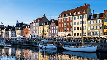 Copenhagen, Denmark – View of Nyhavn (New Haven), a 17th-century waterfront and canal lined with colorful historic townhouses, cafes, and wooden ships.