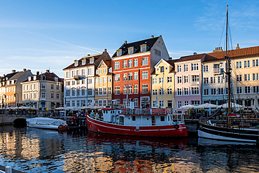 Copenhagen, Denmark – View of Nyhavn (New Haven), a 17th-century waterfront and canal lined with colorful historic townhouses, cafes, and wooden ships.