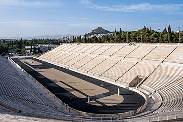 Athens, Greece – View of the Panathenaic Stadium (Kallimarmaro), birthplace of the modern Olympics, with Mount Lycabettus, the city's highest hill, in the background.