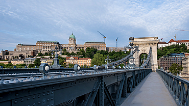 Budapest, Hungary – View from the Chain Bridge with Buda Castle on the left and Sándor Palace on the right rising in the background, atop Castle Hill on the Buda side of the Danube River.