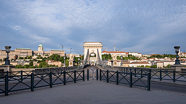 Budapest, Hungary – View from the Chain Bridge with Buda Castle on the left and Sándor Palace on the right rising in the background, atop Castle Hill on the Buda side of the Danube River.