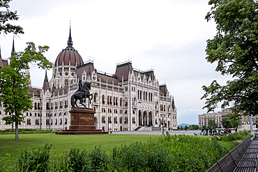 Budapest, Hungary – Architectural detail of the Hungarian Parliament Building, showcasing its Neo-Gothic façade with ornate spires, arched windows, and sculpted figures that reflect Hungary’s medieval heritage and national symbolism.