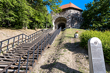 Visegrád, Hungary – View of the entrance to Visegrád Castle (Fellegvár), a fortified gateway atop the Danube Bend, reached by a forested path and metal stairway. A medieval stronghold guarding royal memory.