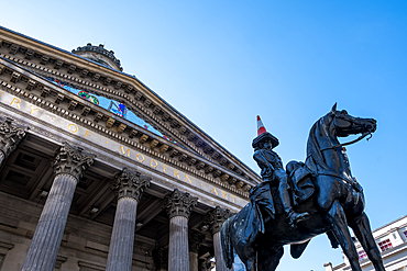 Glasgow, Scotland – Architectural detail of the Gallery of Modern Art with the iconic equestrian statue of the Duke of Wellington in the front, known for its traffic cone tradition.