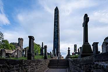 Edinburgh, Scotland – View of Old Calton Cemetery, a historic burial ground featuring classical monuments, weathered gravestones, and the Political Martyrs' Monument obelisk.
