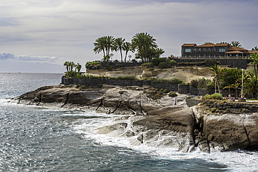 Spectacular coastline of Costa Adeja, with the Atlantic Ocean crashing against the rocky headland, and exotic palm trees, Tenerife, Canary Islands, Spain, Atlantic Ocean, Europe