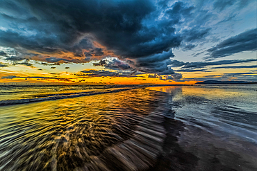 Sunset view from Walney Island across the Irish Sea towards the distant Walney Offshore Wind Farm, Cumbrian Coast, Cumbria, England, United Kingdom, Europe