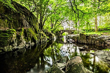 Overcast day in the Eskdale Valley with calm and cold waters from Trough House Bridge and the stunning River Esk, Lake District National Park, UNESCO World Heritage Site, Cumbria, England, United Kingdom, Europe