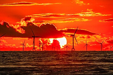 Sunset view towards the distant Walney Offshore wind farm from Walney Island on the Cumbrian Coast, Furness Peninsula, Cumbria, England, United Kingdom, Europe