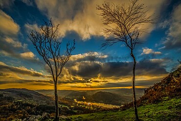 Sunset view from Gummers How in the Lake District, UNESCO World Heritage Site, across Windermere towards the distant Cumbrian Coast and Furness Peninsula, Cumbria, England, United Kingdom, Europe