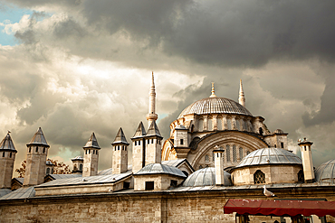 View of the Nuruosmaniye Mosque illuminated by rays against a background of clouds, Istanbul, Turkey, Europe