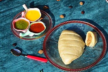 Siddu or sidu is a Himachali dish.fermented steamed bread made from wheat flour stuffed with fillings like urad dal (black lentils) walnut and herbs etc .served with ghee and chutney.