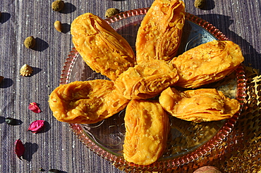 Khaja a deep- fried pastry that is often soaked in sugar syrup or filled with fruits. It is a popular sweet in Odisha India.