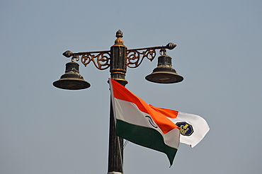 Indian National Flag and Indian Navy flag tied to a lamp post at Gateway of India Mumbai during rehearsals for Indian navy day ceremony