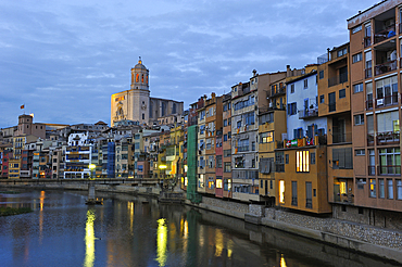 front of the houses by the Onyar River at dusk, with the tower bell of the Cathedral in the background, Girona, Catalonia, Spain,Europe