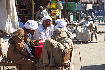 Men sitting in a Daraw street on a market day, Egypt, North Africa, Africa