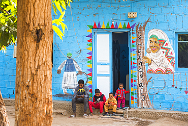 Children in front of the decorated facade of their house, Nubian village on Elephantine Island on the Nile, Aswan, Egypt, North Africa, Africa