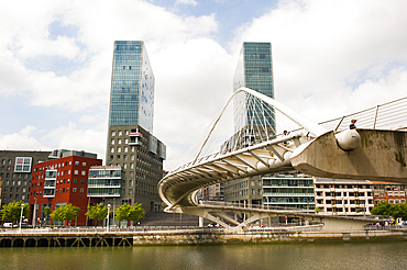 The Zubizuri, tied arch footbridge across the Nervion River, designed by architect Santiago Calatrava, with the Isozaki Atea twin towers designed by Japanese architect Arata Isozaki in the background, Bilbao, province of Biscay, Basque Country, Spain,Europe