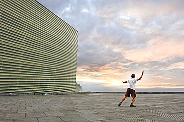 man practising Tai-Chi on esplanade of Kursaal Congress Centre and Auditorium by Spanish architect Rafael Moneo, San Sebastian, Bay of Biscay, province of Gipuzkoa, Basque Country, Spain,Europe