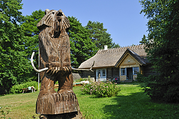 Bear statue made of carved wood, Toomarahva Tourism Farm, situated in the National Park of Lahemaa, in small fishing village of Altja, Estonia, Europe