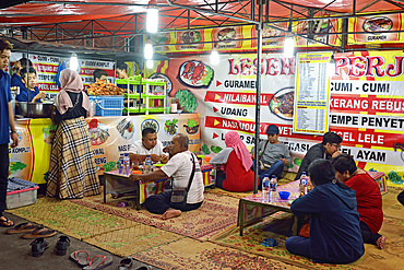 Open-air street side restaurant (lesehan) by night on Malioboro Street, major shopping street in Yogyakarta, Java island, Indonesia, Southeast Asia, Asia