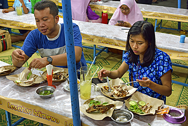 Open-air street side restaurant (lesehan) by night on Malioboro Street, major shopping street in Yogyakarta, Java island, Indonesia, Southeast Asia, Asia