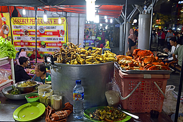 open-air street side restaurant (called lesehan) by night on Malioboro Street, major shopping street in Yogyakarta, Java island, Indonesia, Southeast Asia