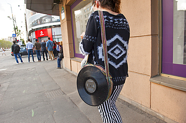 young woman with eccentric handbag walking on Nicolae Balcescu boulevard,Bucharest,Romania,Southeastern and Central Europe