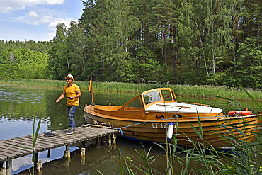 Wooden motorboat trip along the lakes around Paluse, Aukstaitija National Park, Lithuania, Europe