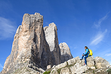 Hiker at the foot of the Tre Cime di Lavaredo (Three Peaks of Lavaredo), Three Peaks Nature Park, Dolomites, UNESCO, South Tyrol, Italy