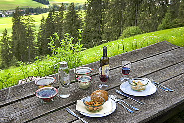 Picnic by chef Chris Oberhammer of Restaurant Tilia at Dobbiaco, on table above Santa Maria, near Dobbiaco, Val Pusteria, South Tyrol (Alto Adige), Italy