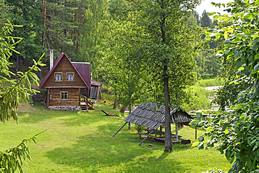 Typical wooden house on the edge of Ukojas lake, near Ginuciai, Aukstaitija National Park, Lithuania, Europe