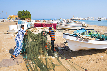 Fishermen on the beach in front of the Al Ayjah village, Sur, port-city, capital of Ash Sharqiyah Region, Sultanate of Oman, Arabian Peninsula