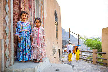 Two little girls, Mosque, Wakan village, Western Hajar Mountains, border South Batinah and Al Dakhiliyah Governorates, Oman, Arabian Peninsula