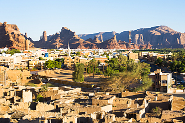 Old mudbrick village under reconstruction with new neighborhoods in the background, in the Old town of AlUla, Medina Province, Saudi Arabia, Middle East