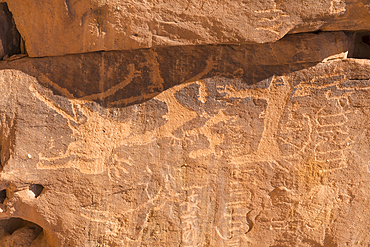 Ancient symbols and rock carvings on a sandstone rock cliff in the Sharaan Nature Reserve, AlUla, Medina Province, Saudi Arabia, Middle East