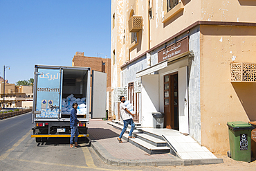 Men delivering ice packs in a street of the new city of AlUla, Medina Province, Saudi Arabia, Middle East