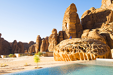 Swimming pool, surrended by magnificent sandstone rock structures, of Our Habitas AlUla, a sustainable desert luxury resort nestled within an ancient oasis in the desert canyons of the Ashar Valley, Medina Province, Saudi Arabia, Middle East