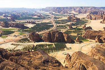 Aerial view, from helicopter, of an ancient oasis in the desert with canyons of the Ashar Valley,AlUla, Medina Province, Saudi Arabia, Middle East