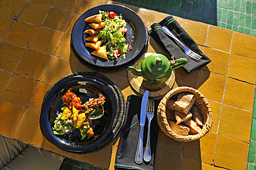 Assortment of Moroccan Salads and mixed briouates, dishes served at the restaurant Le Jardin in the medina, Marrakesh, Morocco, North Africa