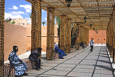 Walkers under a pergola in the Mellah area,Marrakech,Atlas,Morocco,North Africa