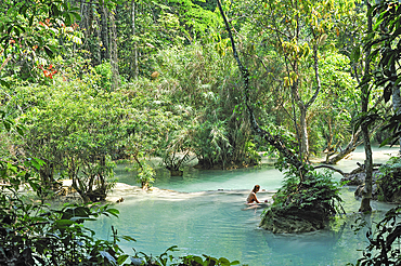 Couple bathing at Kuang Si waterfalls, Luang Prabang, Laos, Southeast Asia