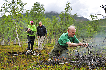 People making a campfire,Nordmannvikdalen valley,region of Lyngen,County of Troms,Norway,Northern Europe