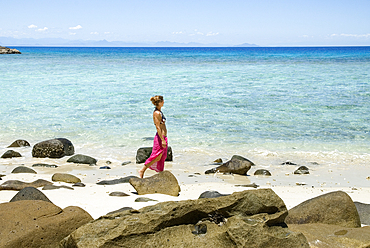 Young woman walking on the beach,Tsarabanjina island,Mitsio archipelago,Republic of Madagascar,Indian Ocean