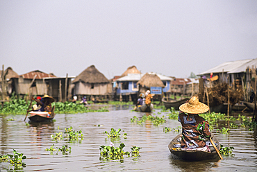 Villagers moving by pirogue on Ganvie lake village in Lake Nokoué, near Cotonou, Gulf of Guinea, West Africa
