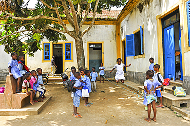 Pupils playing bungee jumping in the playground of the primary school in the village of Praia das Conchas, in the northern part of Sao Tome Island, Republic of Sao Tome and Principe,Africa